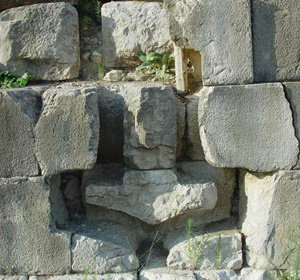 View of one of the sockets cut into the long wall below the battle monument at Actium