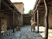 View of the central courtyard (showing a hypothetical family of beekeepers) from the Vari House extracted from the virtual reality model of the site; © 2011 Learning Sites, Inc.