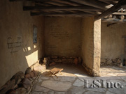 View of the workspace (with beeskeps) off the courtyard in the Vari House extracted from the virtual reality model of the site; © 2011 Learning Sites, Inc.